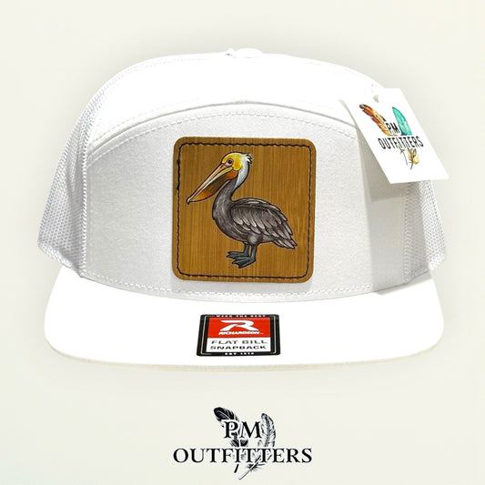 Hand-painted Brown Pelican patch on a white Richardson 168 flat-bill snapback hat, PM Outfitters True Originals