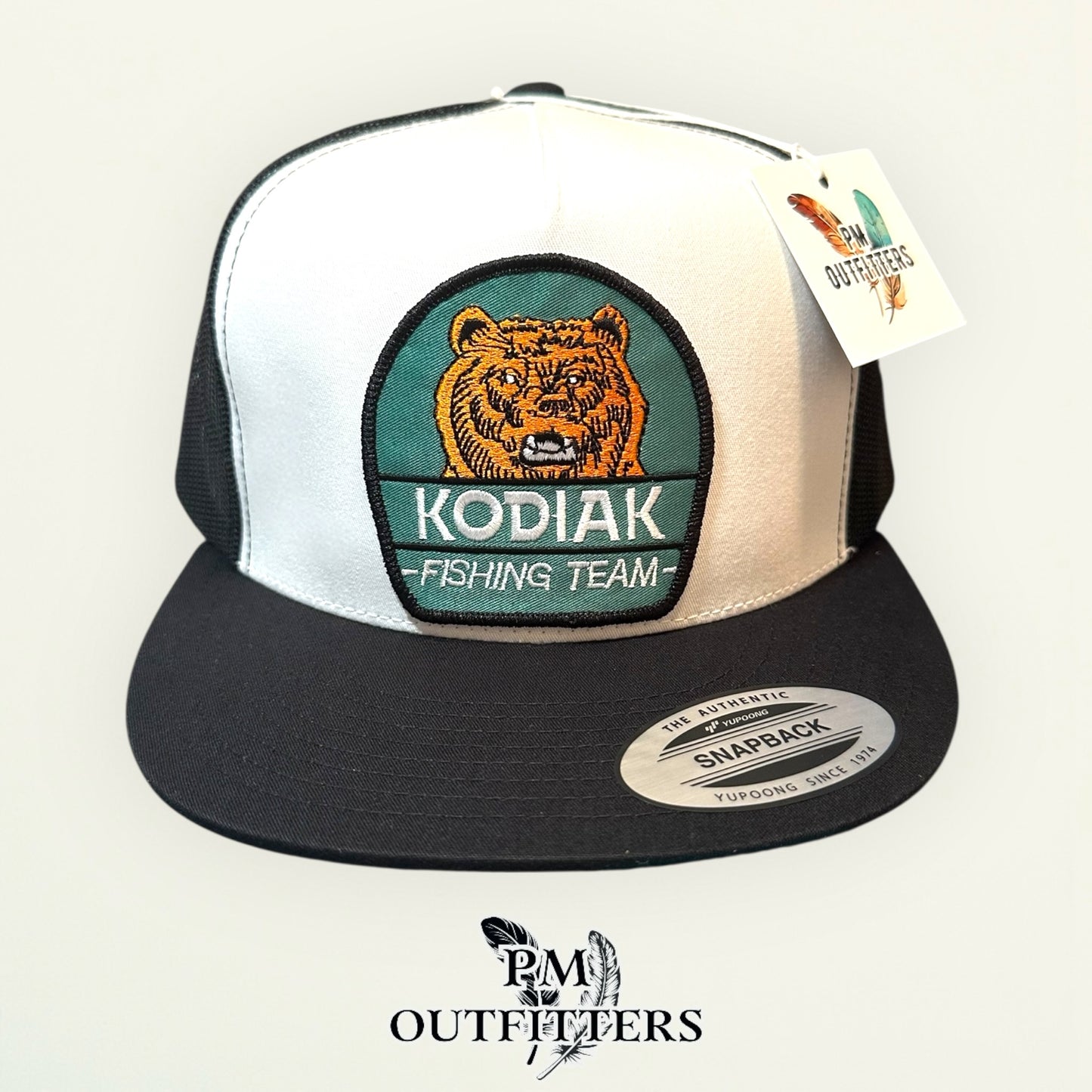 Kodiak Fishing Team Trucker Hat — PM Outfitters Heritage Patch | Yupoong Flat Bill White Black Alaska Wilderness