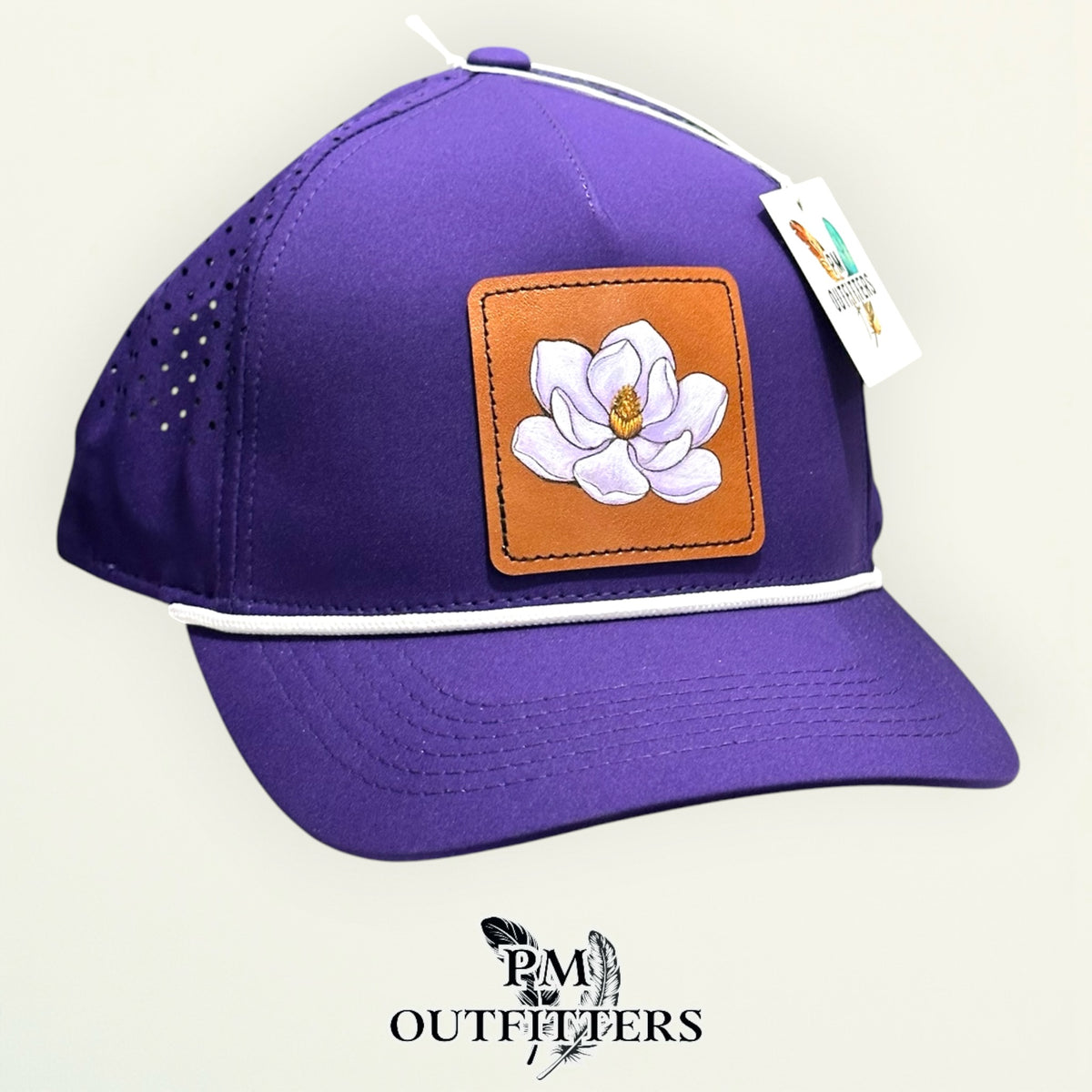 Purple Outdoor Cap OC551PF performance rope cap with hand-painted magnolia patch, angled view, PM Outfitters True Originals