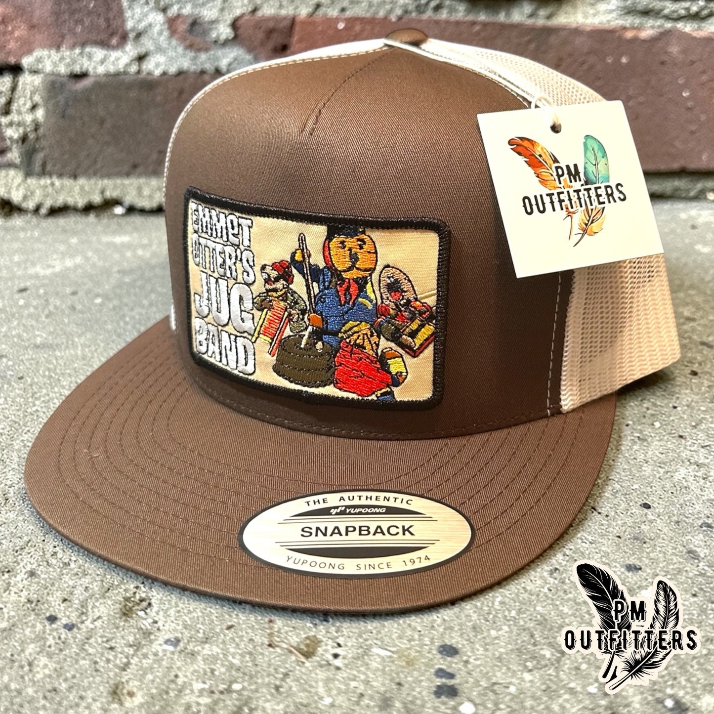 Emmet Otter's Jug Band Trucker Hat — PM Outfitters Retro Patch | Yupoong Flat Bill Brown White Jim Henson Heritage