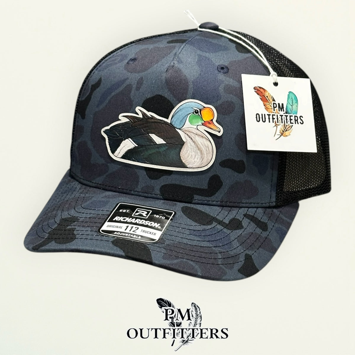 Back of the Admiral duck camo trucker hat showing the mesh panels and snapback closure, PM Outfitters True Originals