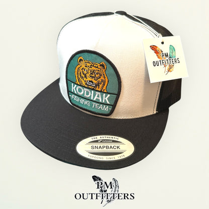 Kodiak Fishing Team Trucker Hat — PM Outfitters Heritage Patch | Yupoong Flat Bill White Black Alaska Wilderness
