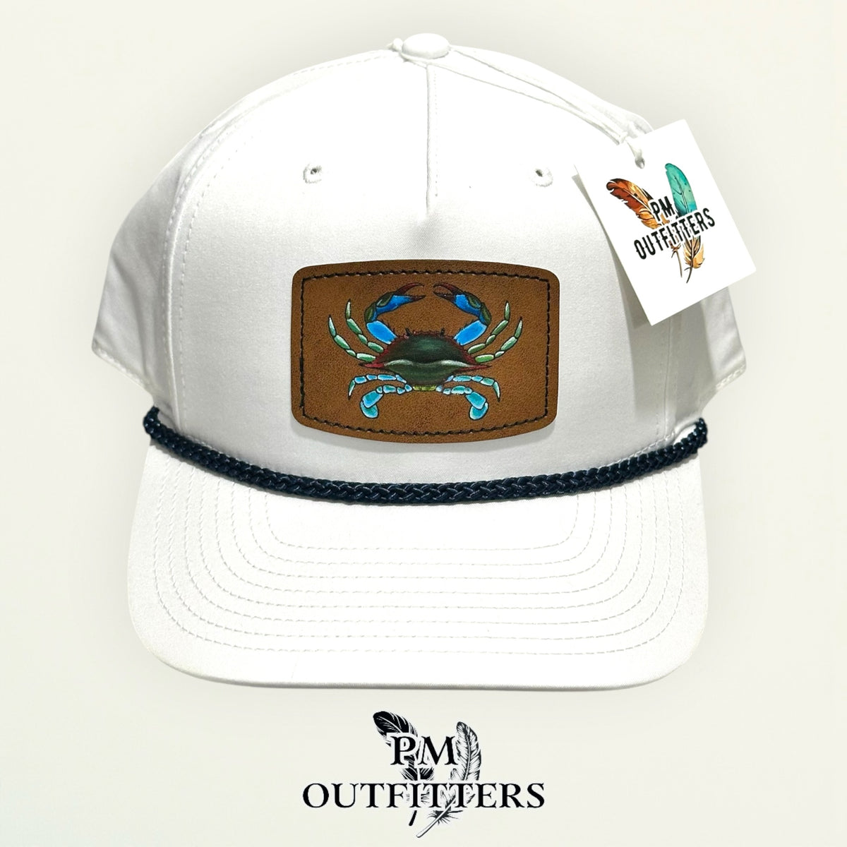 Hand-painted blue crab patch on a white Richardson 258 rope trucker hat with navy trim, PM Outfitters True Originals