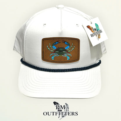 Hand-painted blue crab patch on a white Richardson 258 rope trucker hat with navy trim, PM Outfitters True Originals