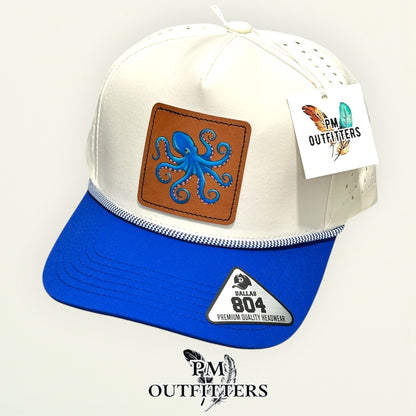 Hand-painted octopus performance rope cap displayed with PM Outfitters branded hang tag