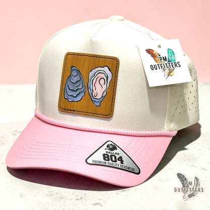 Hand-painted Gulf oyster patch on a cream and pink Dallas 804 waterproof rope trucker hat, PM Outfitters True Originals