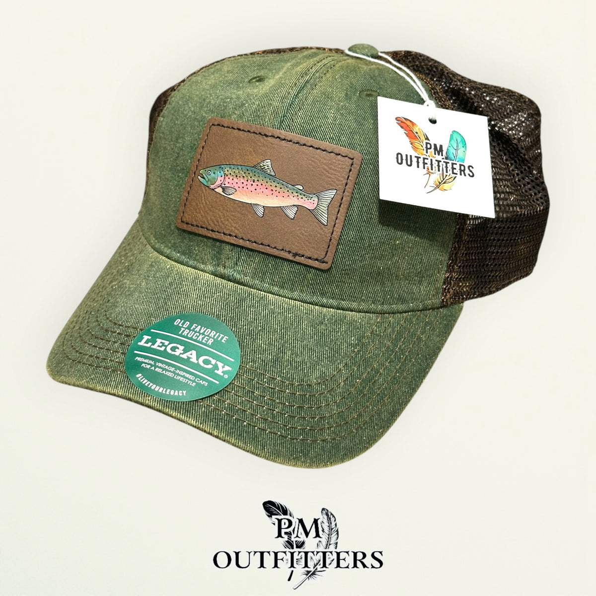 Hand-painted rainbow trout patch on an olive Legacy Old Favorite trucker hat with bronze mesh back, PM Outfitters True Originals