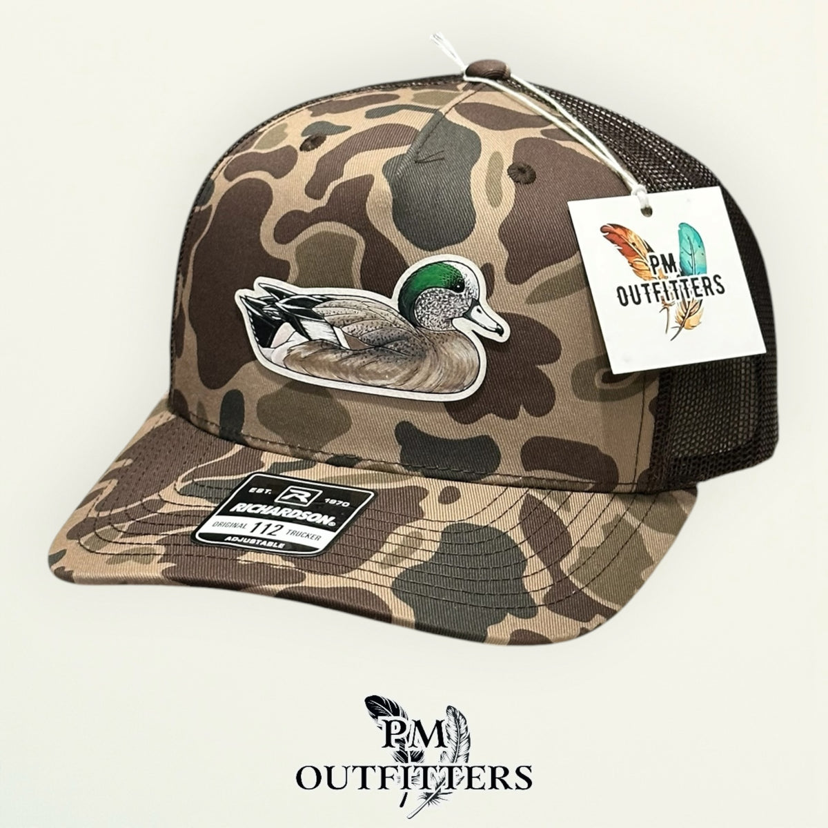 Back of the Bark duck camo trucker hat showing the mesh panels and snapback closure, PM Outfitters True Originals