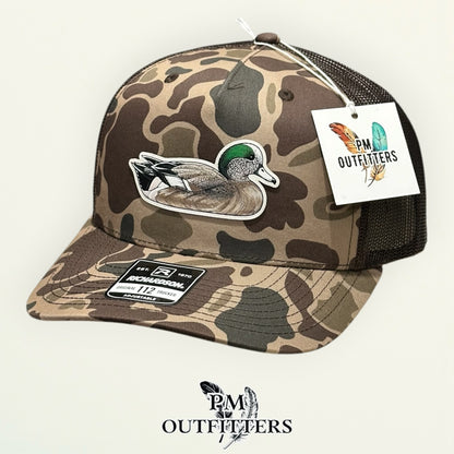 Back of the Bark duck camo trucker hat showing the mesh panels and snapback closure, PM Outfitters True Originals