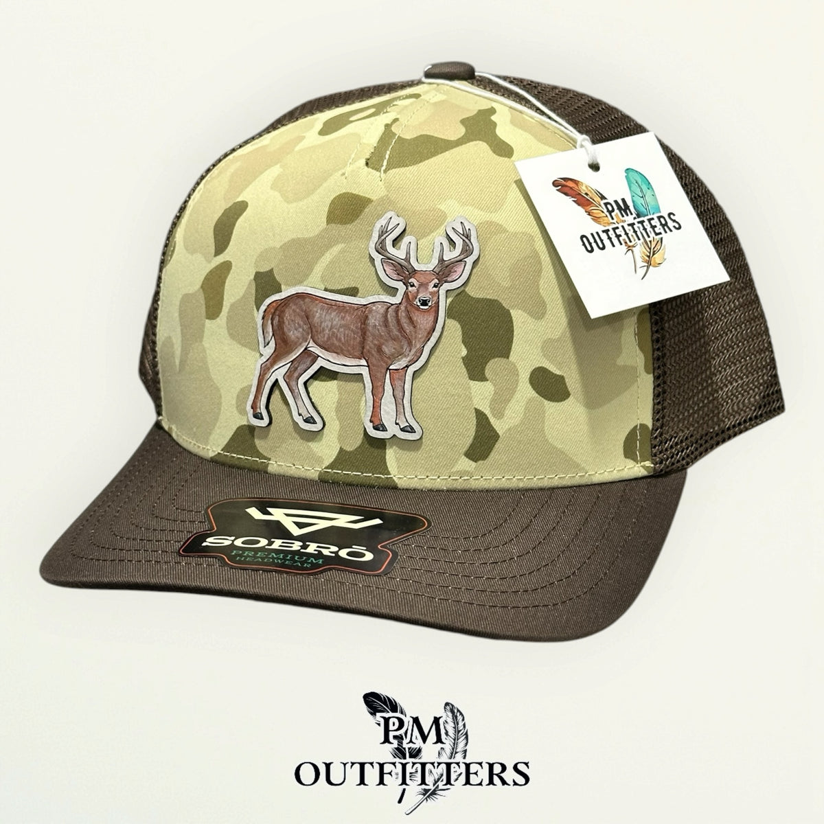 Hand-painted whitetail buck trucker hat in tan and olive camo with brown bill, PM Outfitters True Originals