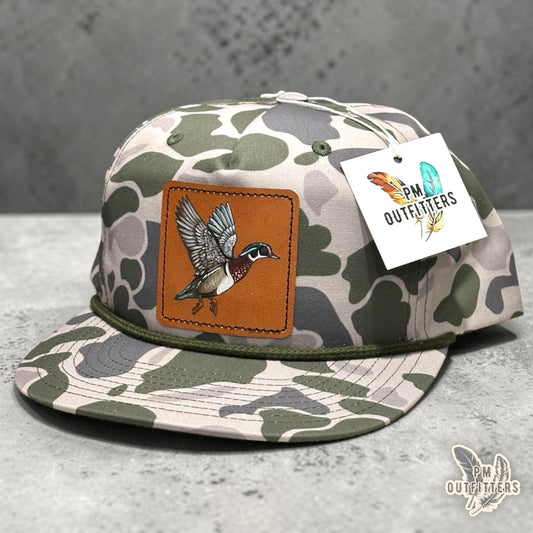 Hand-painted Wood Duck patch on a marsh duck camo Richardson 256P rope trucker hat, PM Outfitters True Originals