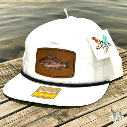 Hand-painted redfish patch on a white Richardson 256 performance rope cap with black rope trim, PM Outfitters True Originals