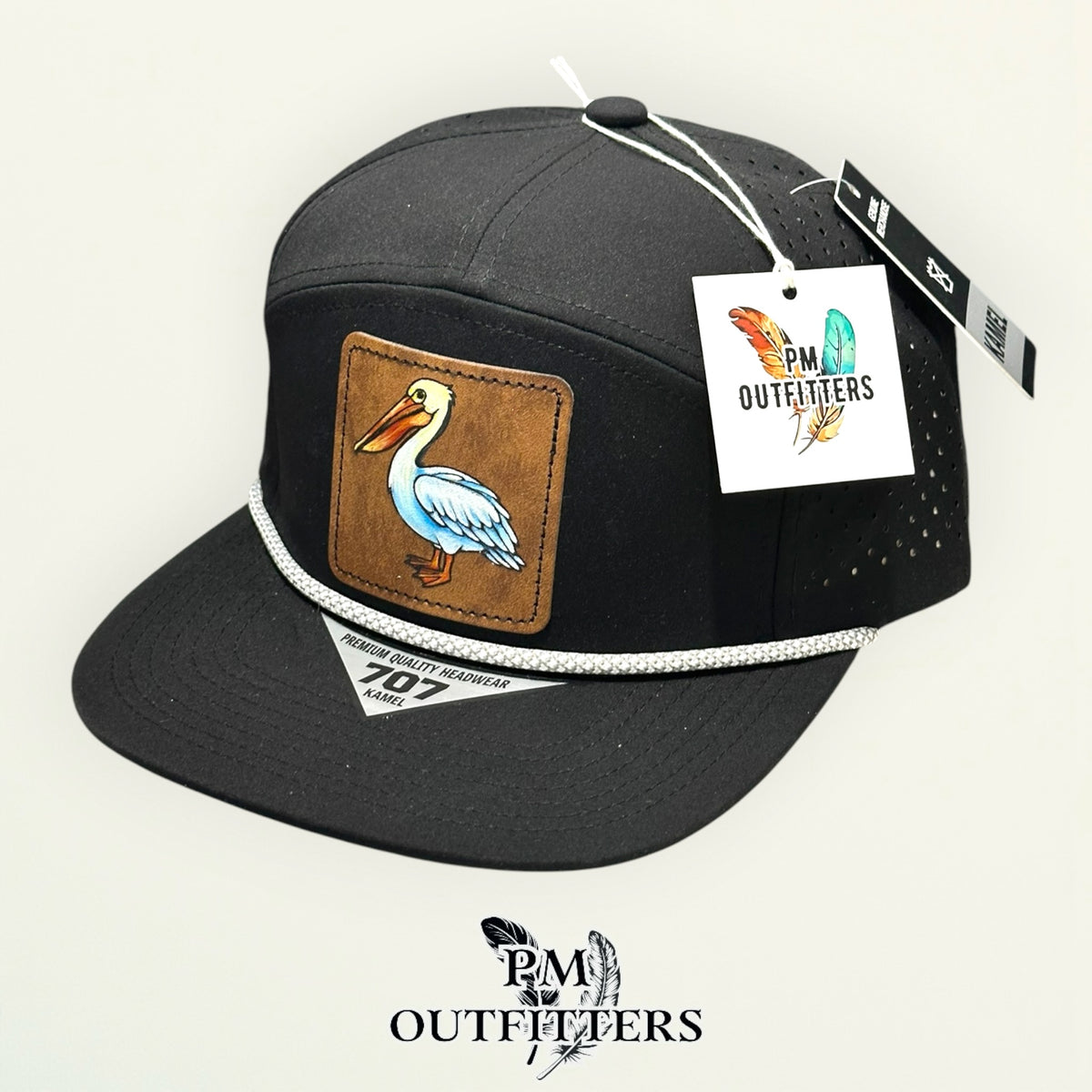 Hand-painted white pelican performance rope cap displayed with PM Outfitters branded hang tag