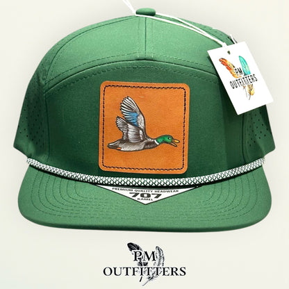 Side view of the hand-painted mallard duck patch on the green Kamel 707 rope cap, PM Outfitters True Originals