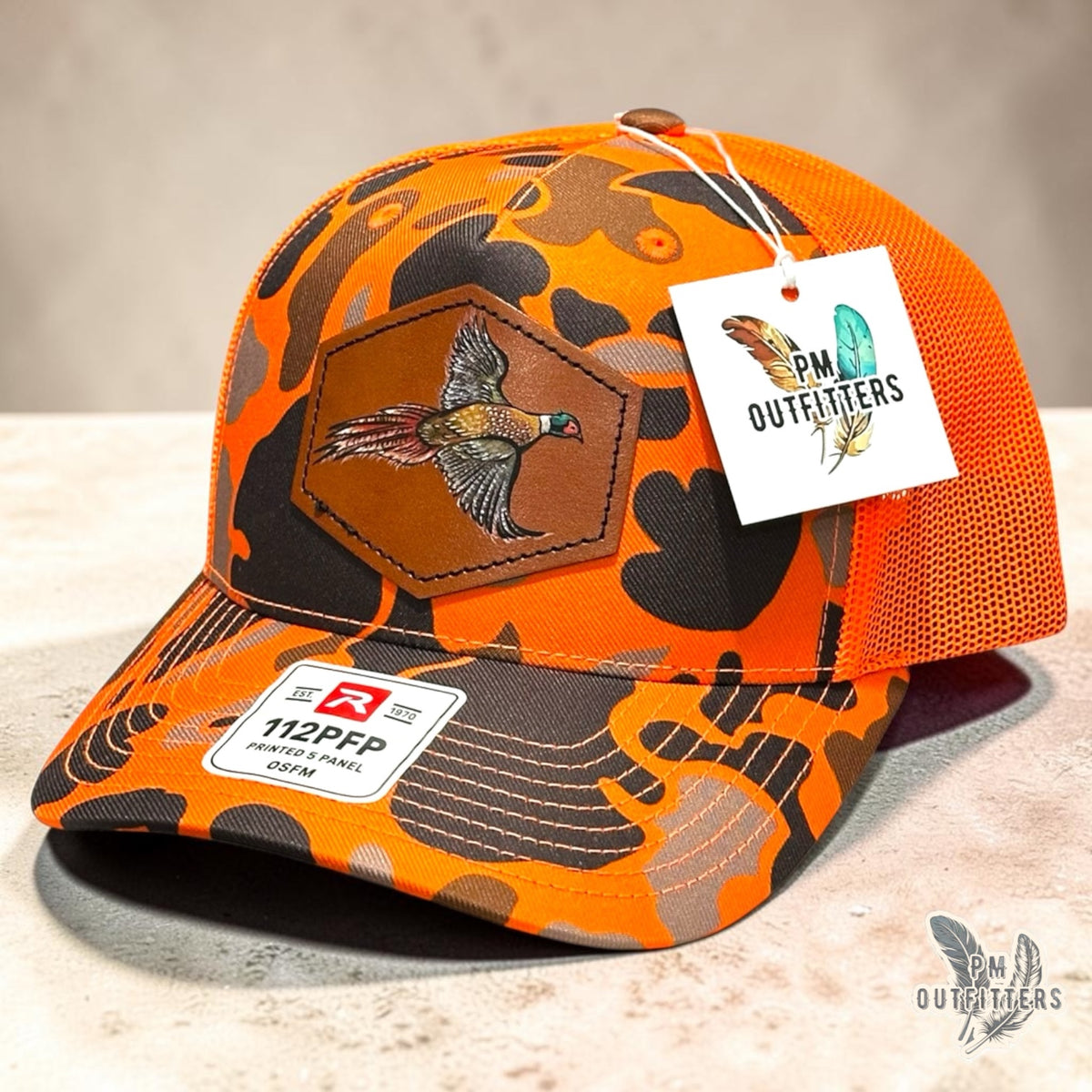 Hand-painted Pheasant patch on a blaze duck camo Richardson 112PFP trucker hat, PM Outfitters True Originals