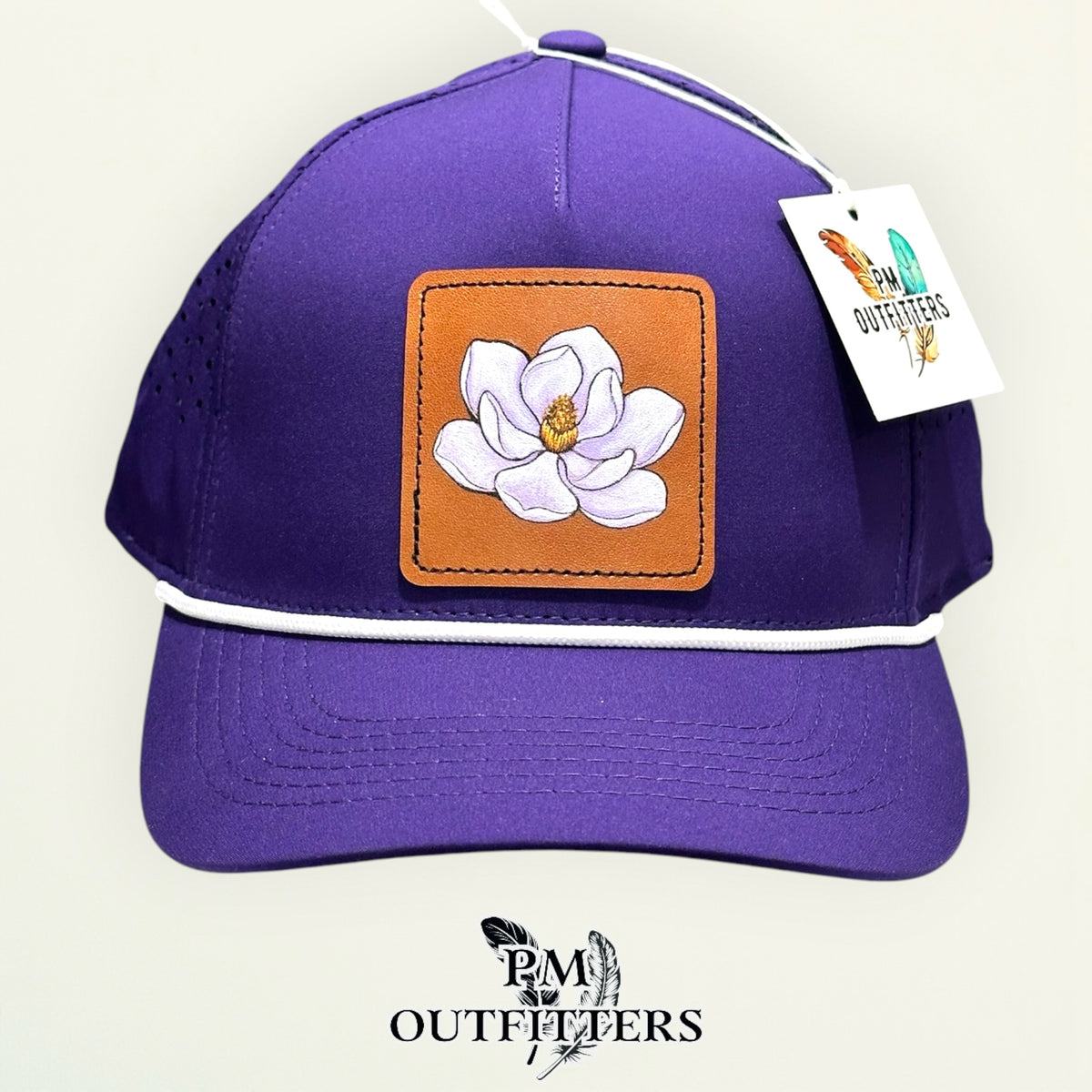 Side view of the hand-painted magnolia patch on the purple rope cap, PM Outfitters True Originals
