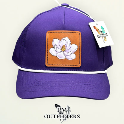 Side view of the hand-painted magnolia patch on the purple rope cap, PM Outfitters True Originals