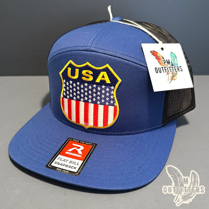 USA Shield Patch Trucker Hat — Retro American Flag Embroidered Patch | Richardson 168 7-Panel Flat Bill Blue Black