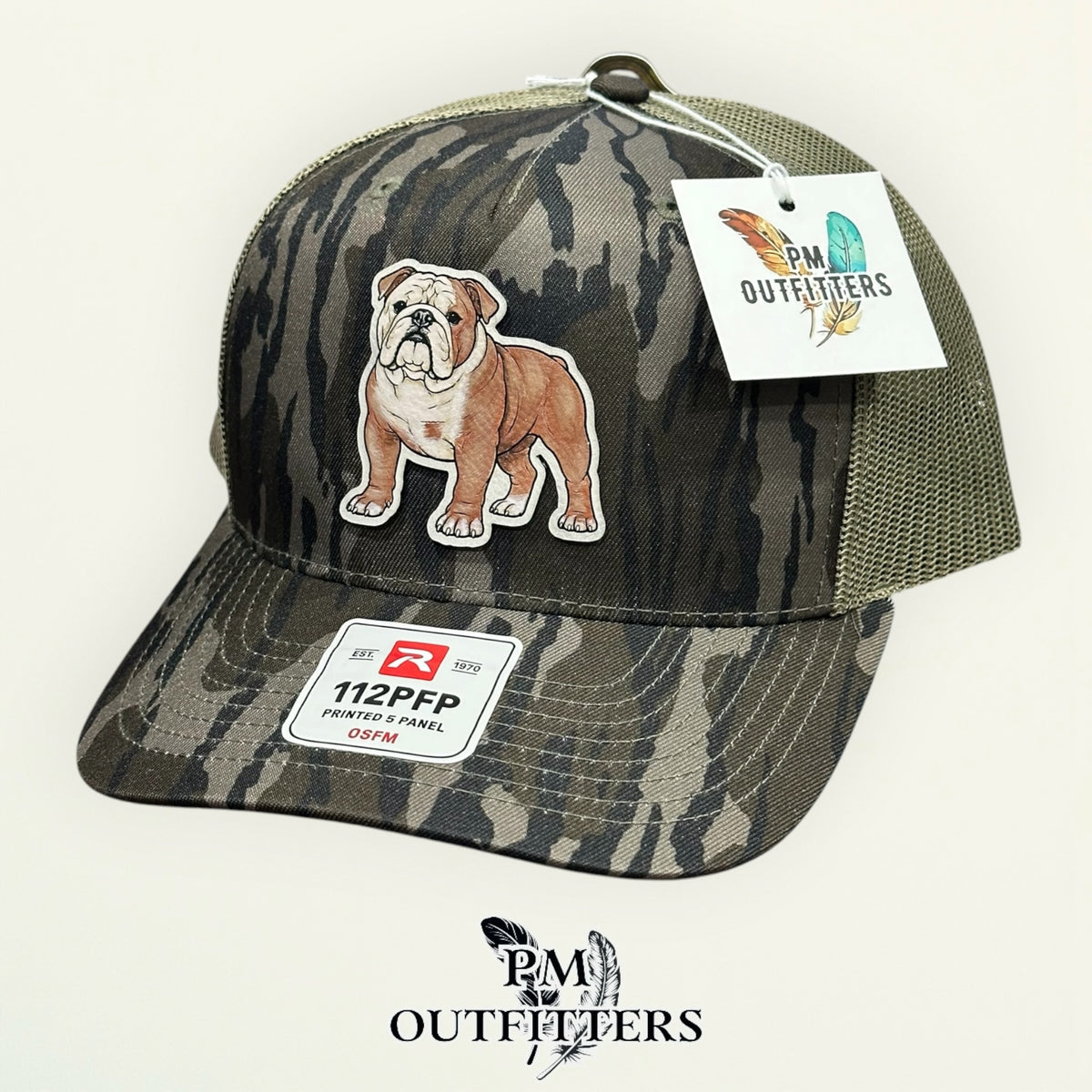Back of the Mossy Oak Bottomland camo Richardson 112PFP trucker hat showing the mesh panels and adjustable closure, PM Outfitters True Originals