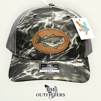 Side view of the hand-painted bass patch on the Mossy Oak Elements Blacktip camo trucker hat, PM Outfitters True Originals