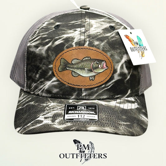 Side view of the hand-painted bass patch on the Mossy Oak Elements Blacktip camo trucker hat, PM Outfitters True Originals