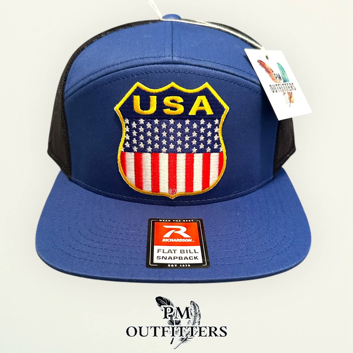 USA Shield Patch Trucker Hat — Retro American Flag Embroidered Patch | Richardson 168 7-Panel Flat Bill Blue Black