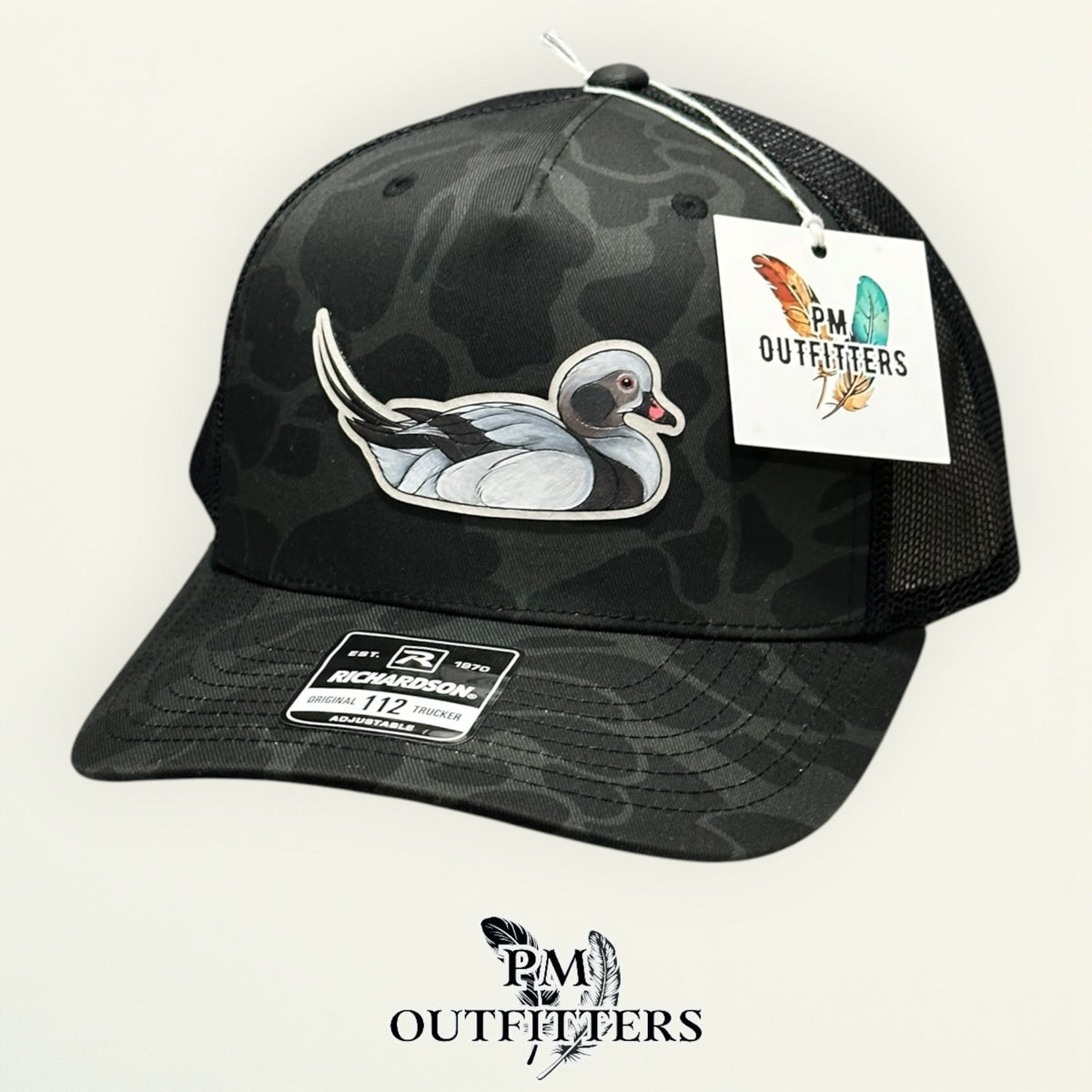 Back of the Sable duck camo trucker hat showing the mesh panels and snapback closure, PM Outfitters True Originals