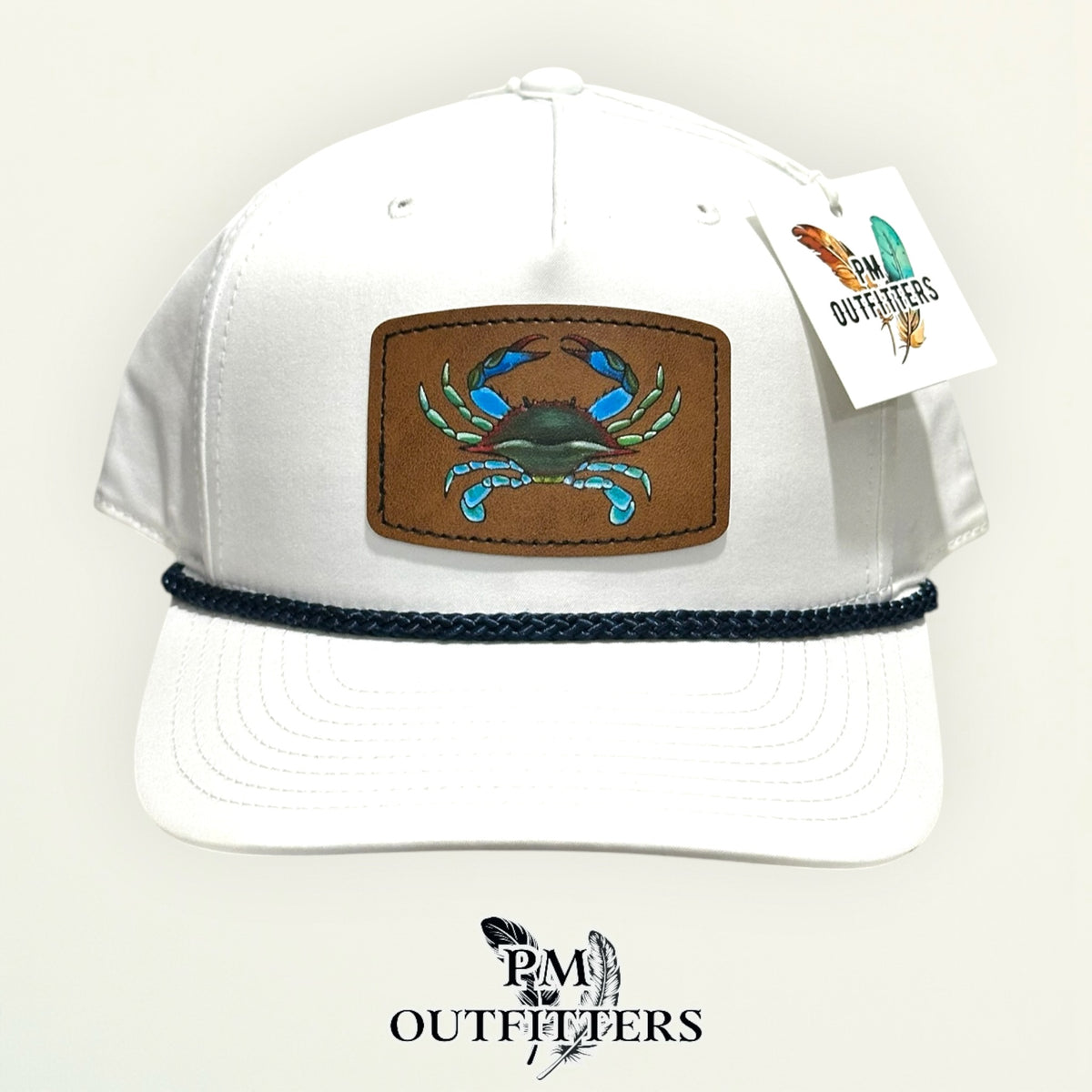 Hand-painted blue crab patch on a white Richardson 258 rope trucker hat with navy trim, PM Outfitters True Originals
