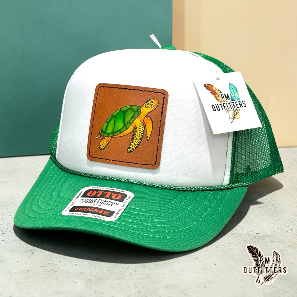 Hand-painted sea turtle patch on a white and green Otto foam front trucker hat, PM Outfitters True Originals