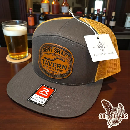 Bent Shaft Tavern Trucker Hat - Custom Leatherette Patch Richardson 168 | Grey Gold Flat Bill Humor Cap