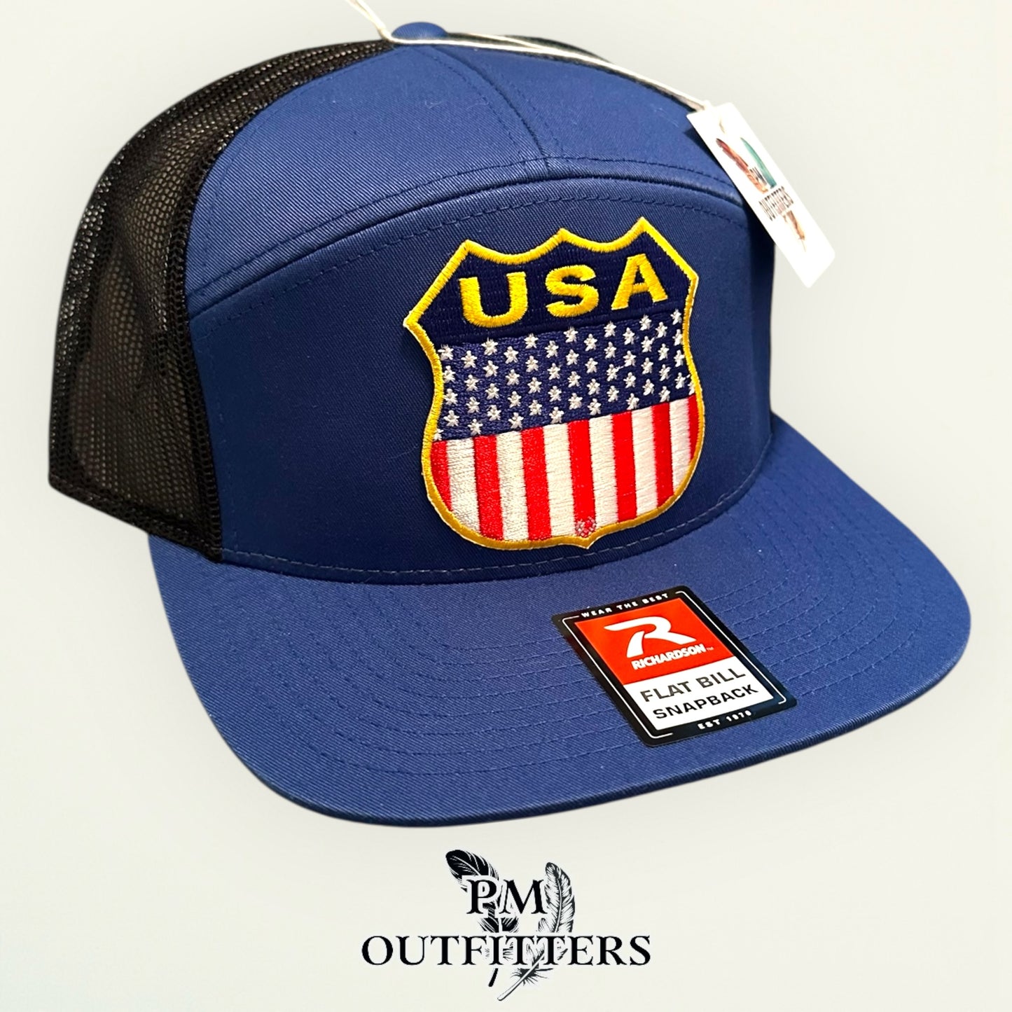 USA Shield Patch Trucker Hat — Retro American Flag Embroidered Patch | Richardson 168 7-Panel Flat Bill Blue Black
