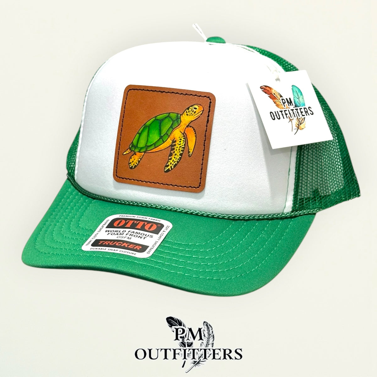 White and green Otto foam front trucker hat with hand-painted sea turtle patch, angled view, PM Outfitters True Originals