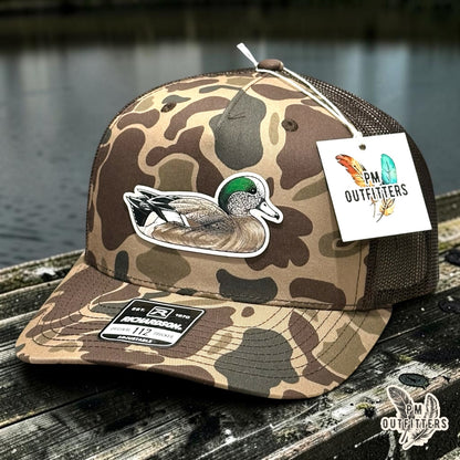 Hand-painted American Wigeon patch on a Richardson 112PFP Bark duck camo trucker hat, PM Outfitters True Originals