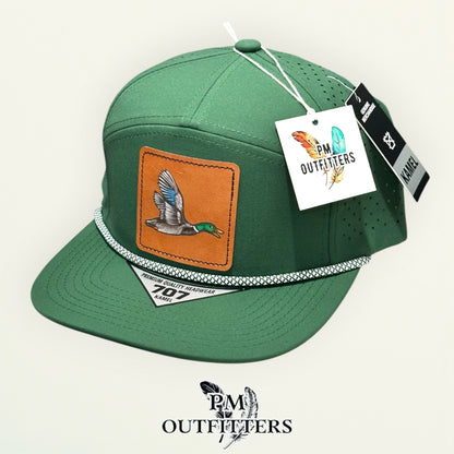 Hand-painted mallard duck performance rope cap displayed with PM Outfitters branded hang tag
