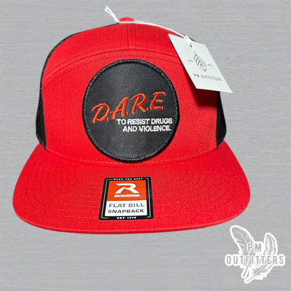 Red and black Richardson 168 7-panel trucker hat with retro DARE embroidered patch, vintage style.