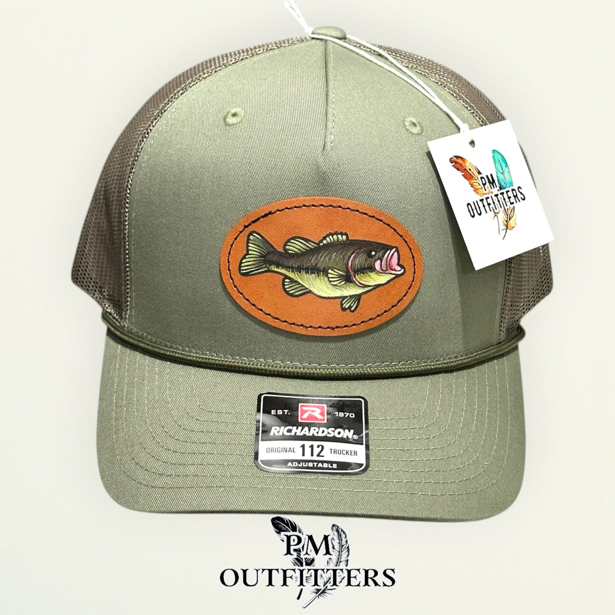 Side view of the hand-painted bass patch on the loden green Richardson 112 trucker hat, PM Outfitters True Originals