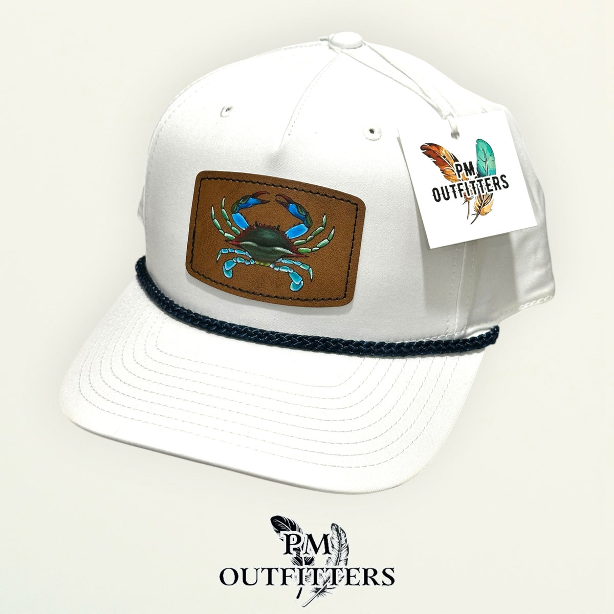 Hand-painted blue crab patch on a white Richardson 258 rope trucker hat with navy trim, PM Outfitters True Originals
