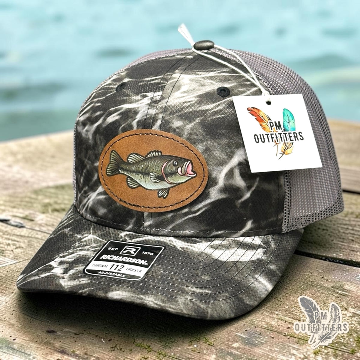 Hand-painted largemouth bass patch on a Richardson 112 Mossy Oak Elements Blacktip camo trucker hat, PM Outfitters True Originals