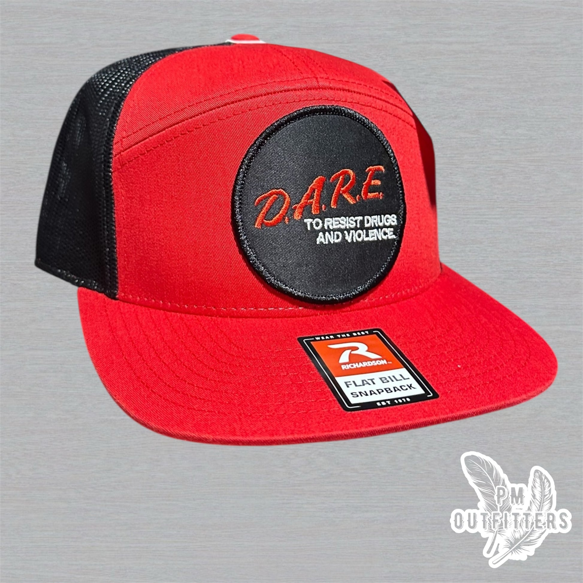 Red and black Richardson 168 7-panel trucker hat with retro DARE embroidered patch, vintage style.