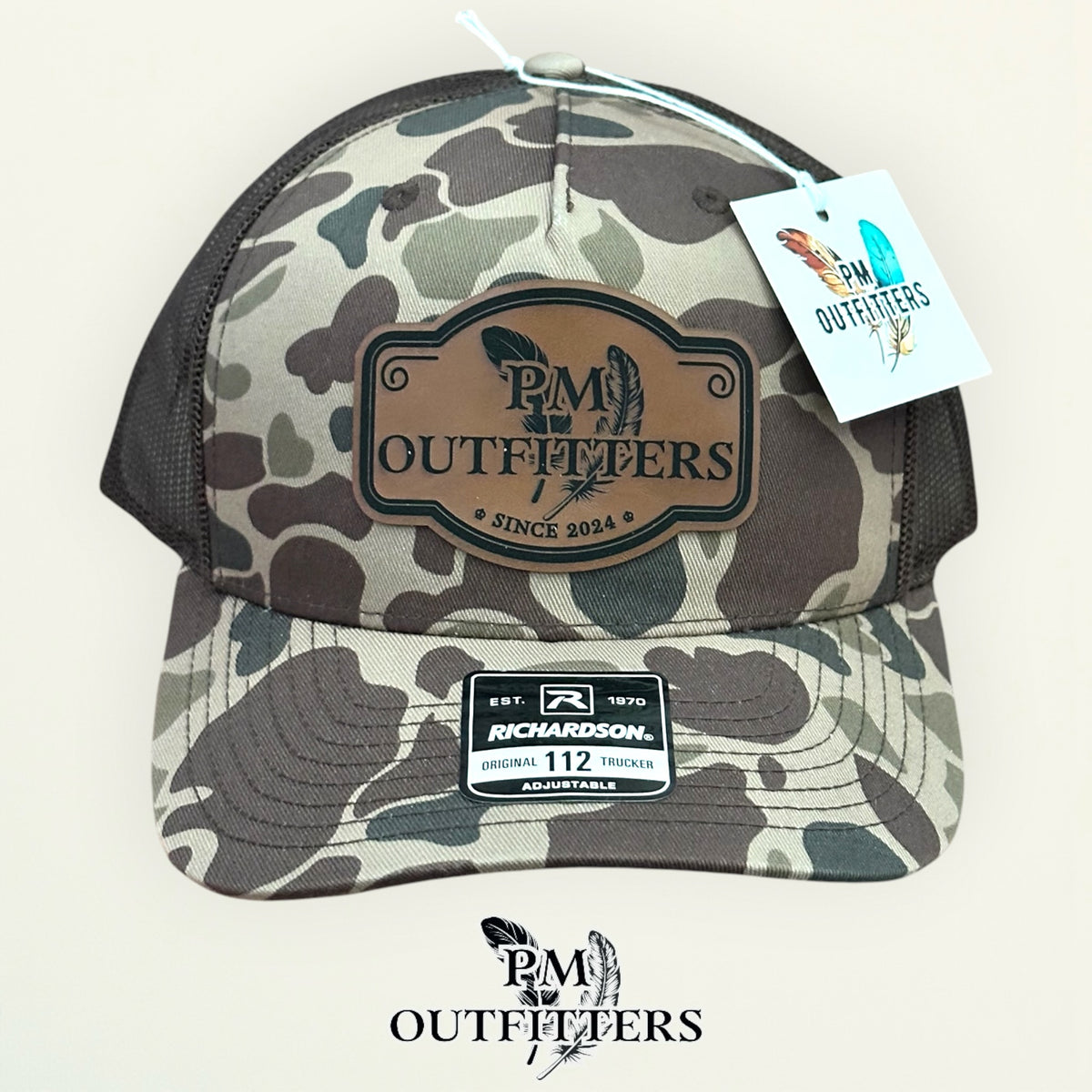 PM Outfitters hang tag Bark Duck camo trucker hat