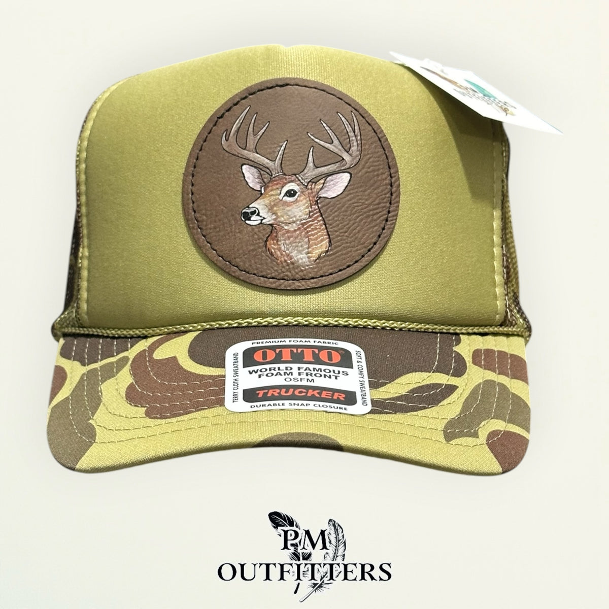 Olive green and camo Otto foam front trucker hat with hand-painted whitetail buck patch, PM Outfitters True Originals