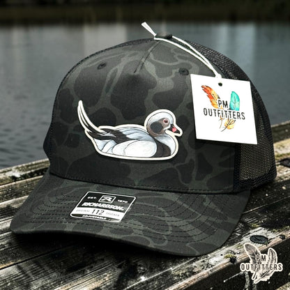 Hand-painted Long-Tailed Duck patch on a Richardson 112PFP Sable duck camo trucker hat, PM Outfitters True Originals
