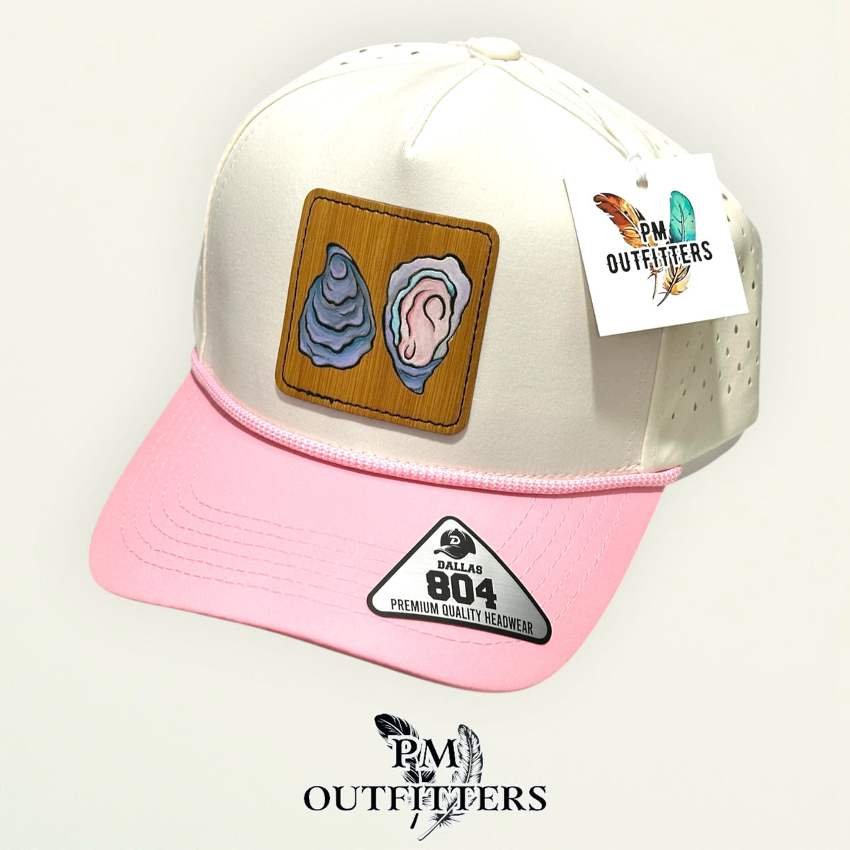 Hand-painted Gulf oyster patch on a cream and pink Dallas 804 waterproof rope trucker hat, PM Outfitters True Originals