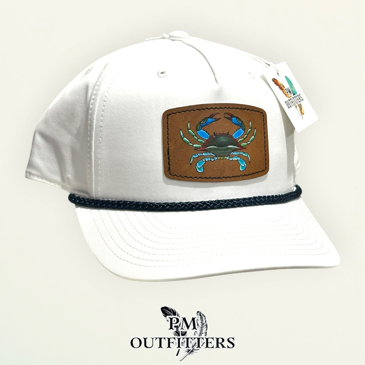 Hand-painted blue crab patch on a white Richardson 258 rope trucker hat with navy trim, PM Outfitters True Originals
