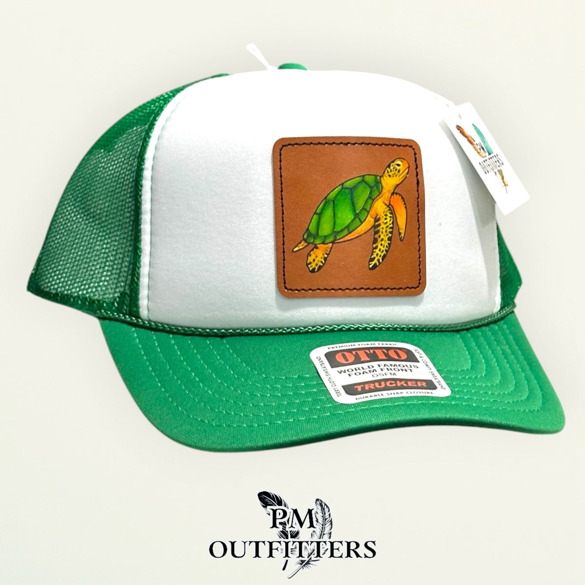 Back of the white and green Otto trucker hat showing the mesh panels and snap closure, PM Outfitters True Originals