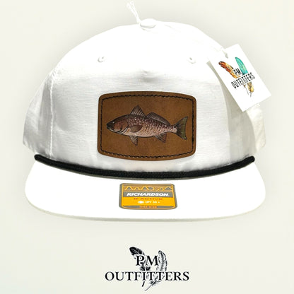Side view of the hand-painted redfish patch on the white Richardson 256 rope cap, PM Outfitters True Originals