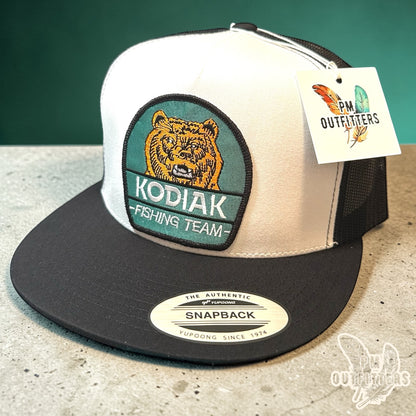 Kodiak Fishing Team Trucker Hat — PM Outfitters Heritage Patch | Yupoong Flat Bill White Black Alaska Wilderness
