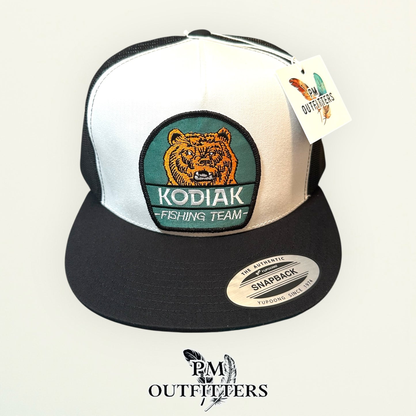 Kodiak Fishing Team Trucker Hat — PM Outfitters Heritage Patch | Yupoong Flat Bill White Black Alaska Wilderness