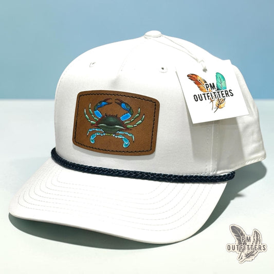 Hand-painted blue crab patch on a white Richardson 258 rope trucker hat with navy trim, PM Outfitters True Originals