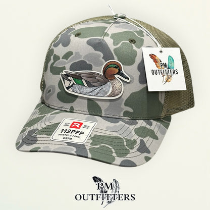 Back of the Marsh duck camo trucker hat showing the mesh panels and snapback closure, PM Outfitters True Originals
